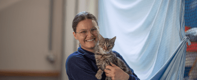 Smiling woman holding a cat